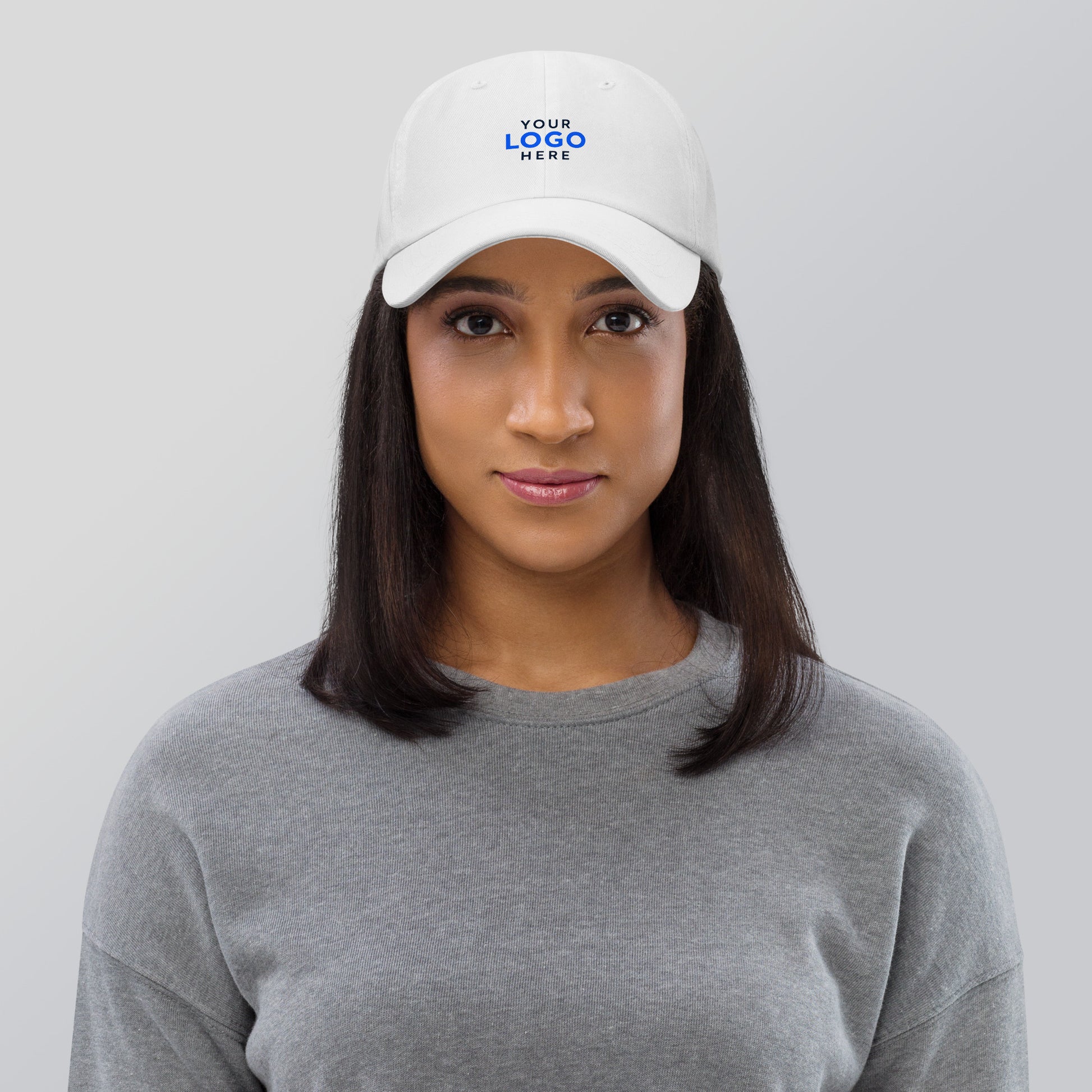 White cotton dad hat embroidered with a company logo for corporate branding